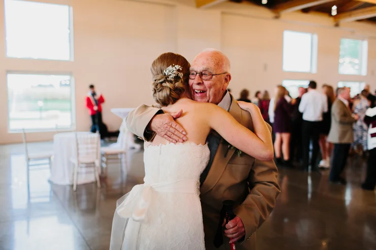 Bride hugging grandpa at wedding reception Pear Tree Estate Champaign, IL