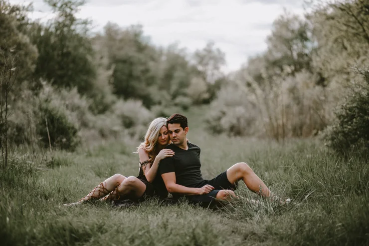Moody portraits of a couple wearing boho free people clothing in Illinois field