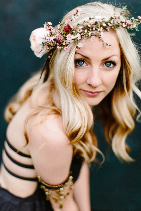 Girl posing in front of a dark blue backdrop wearing free people boho clothing and flower crown