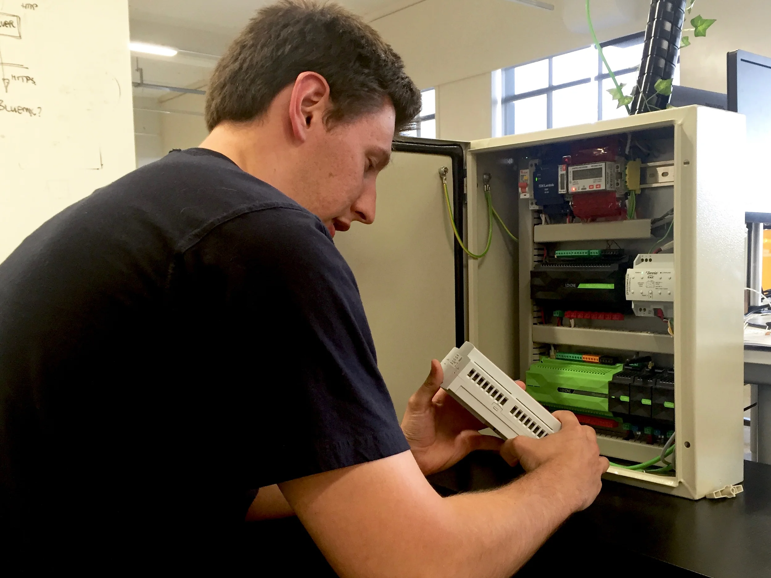 Graduate Controls Engineer James in the Evident office.