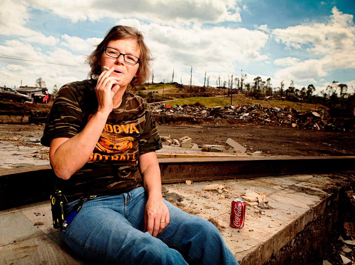 Yvonne - this picture says it all. Yvonne is sitting where The Rebel Queen used to be. She was a waitress there and her husband owned the business. On April 27, 2011 she sought quick shelter from tornado #2 (the worst one) inside the men's room - but had the wherewithal to remember here 12 pack of Coca-Cola! Nothing was left of the Rebel Queen except the men's room where she had been. When leaving she turned around to find a Jeep was on top of the men's room but was being held up by a bent pipe - the pipe Yvonne had been underneath. 