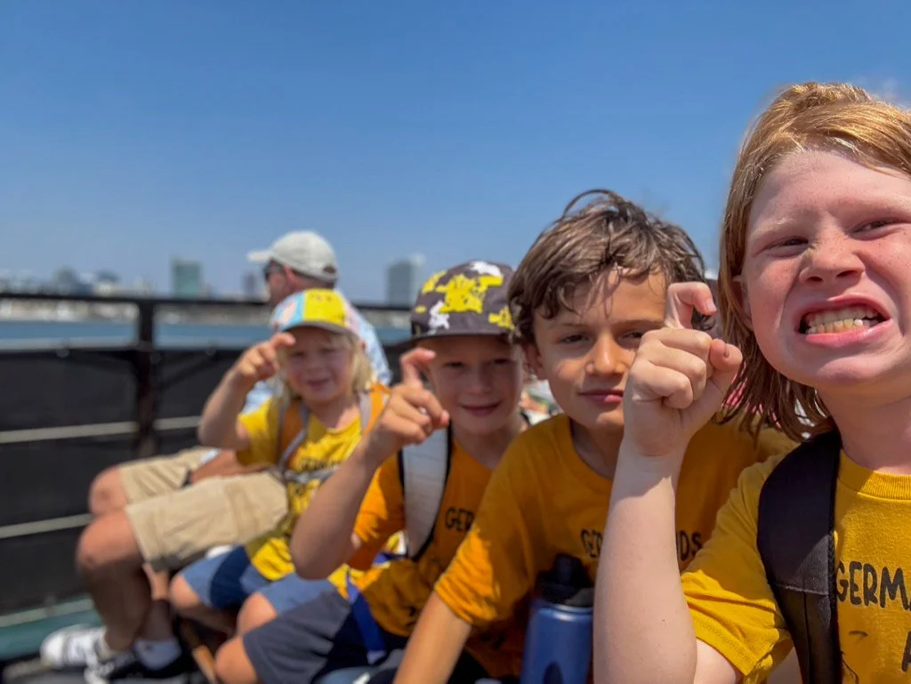 Summer camp participants sitting next to each other during a day trip.