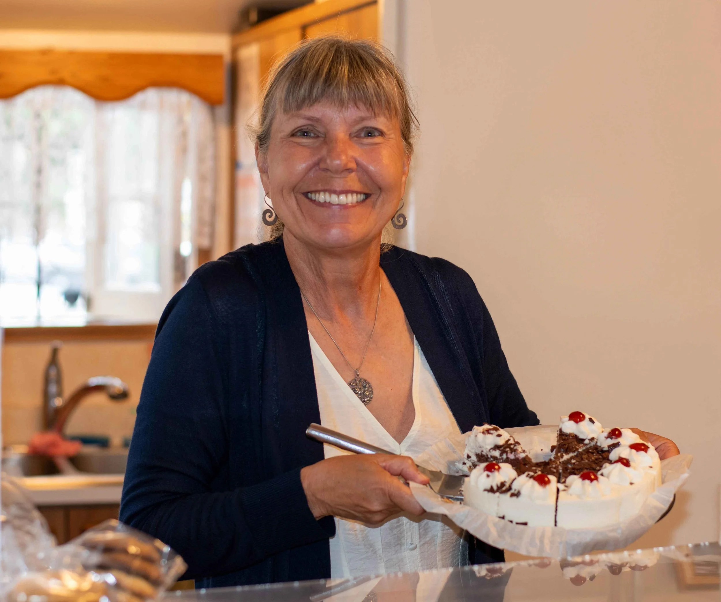 Member serving German cake at the House of Germany cottage