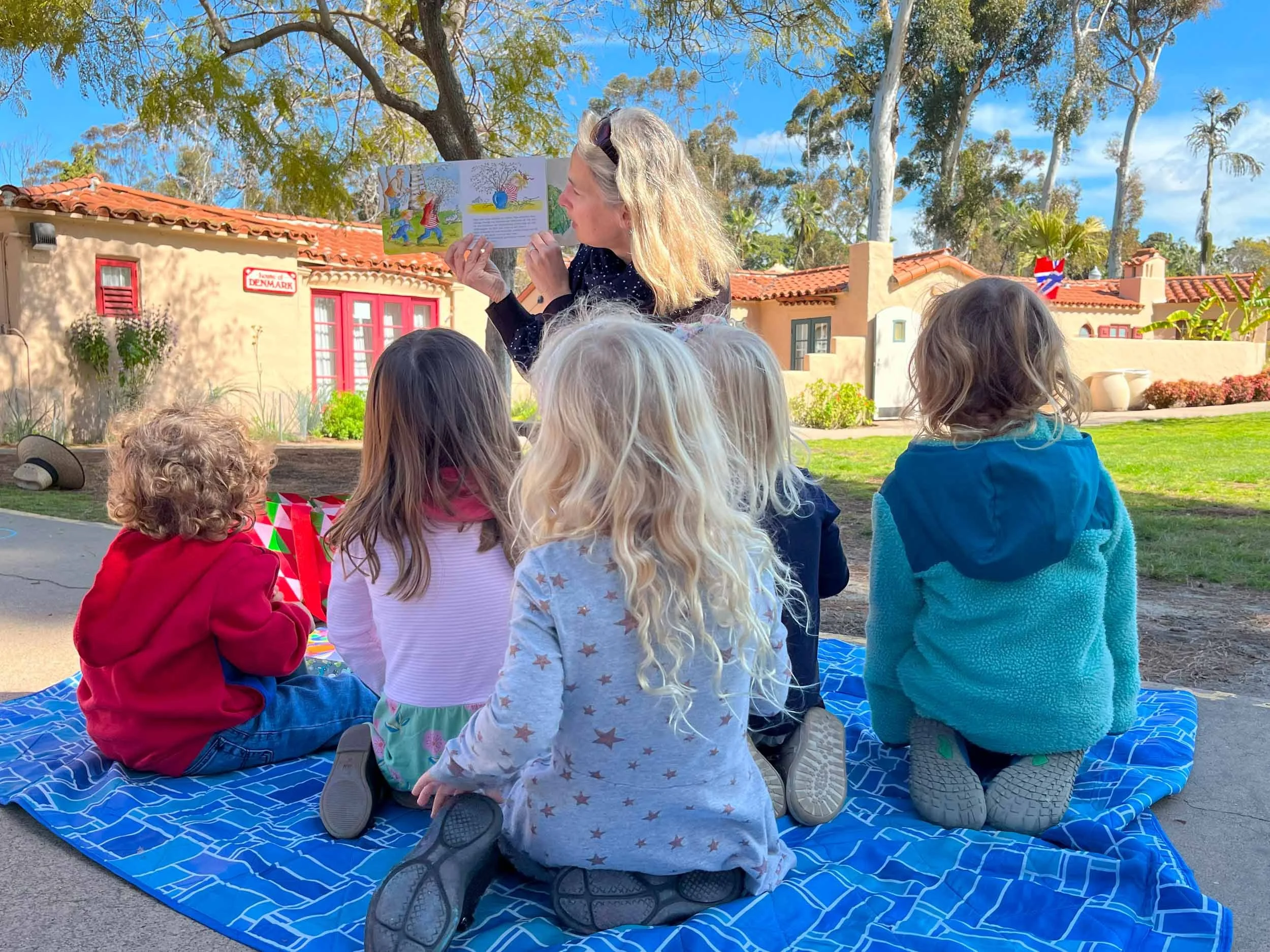 Group of Knirpse students listening to Frau Anna reading a book