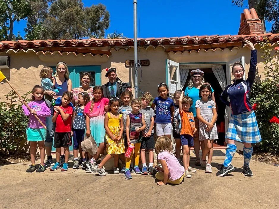 A group of Kinderwerkstatt students posing with their teachers near the International Cottages.