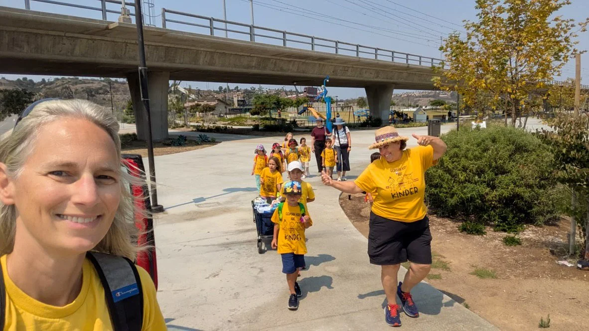 Summer camp participants and their teachers walking during a day trip.