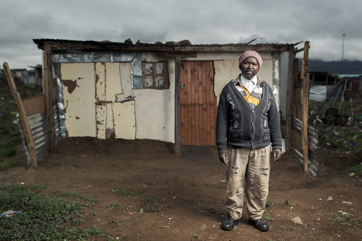 Mthuthuzeli Mtshange infront of his shack on the outskirts of Queenstown, Eastern Cape. 