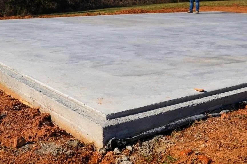 Newly poured and leveled concrete slab foundation for a residential or commercial building project.