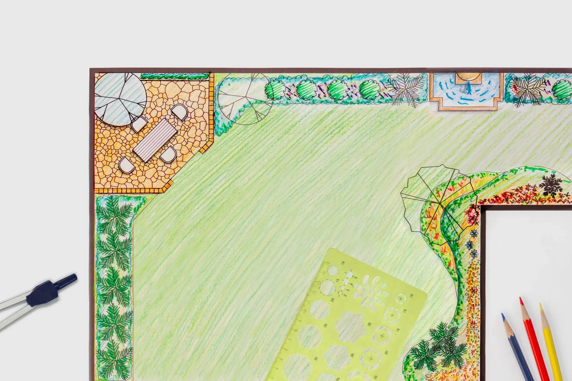 Hand-drawn garden landscape design plan featuring a patio area, lawn, and flower beds with architectural drawing tools.