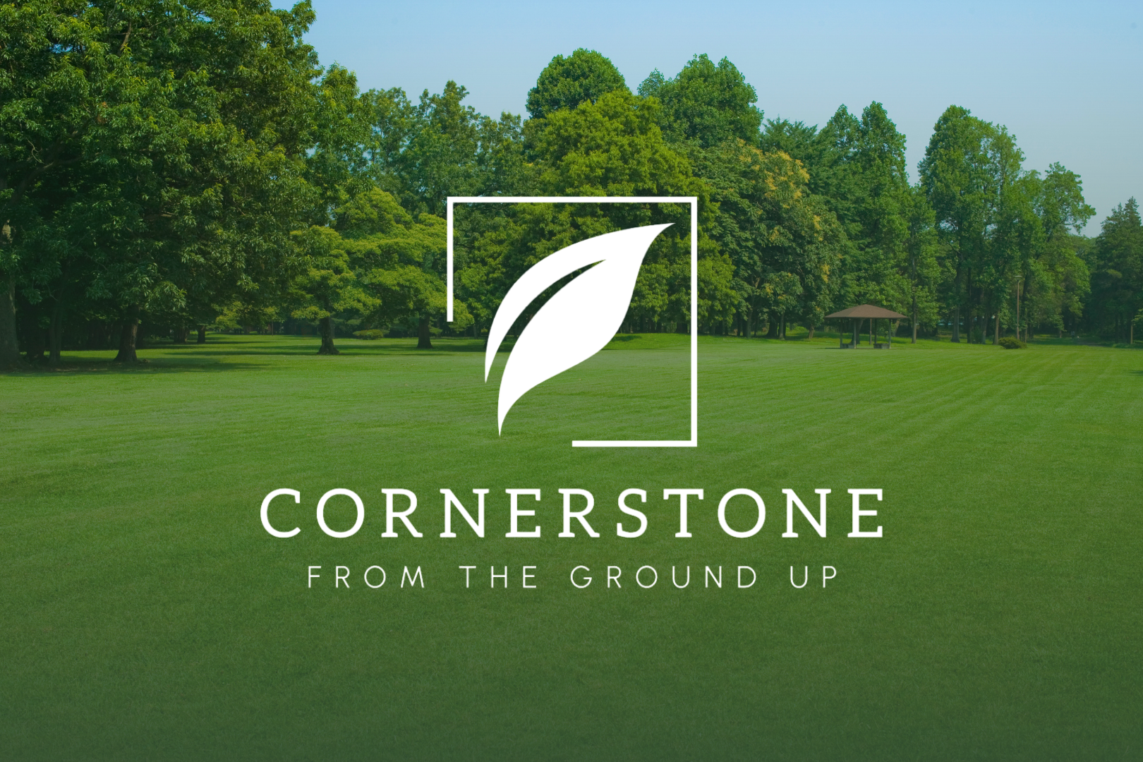 The Cornerstone Lawn Services logo with the tagline "FROM THE GROUND UP" over a lush green park landscape.