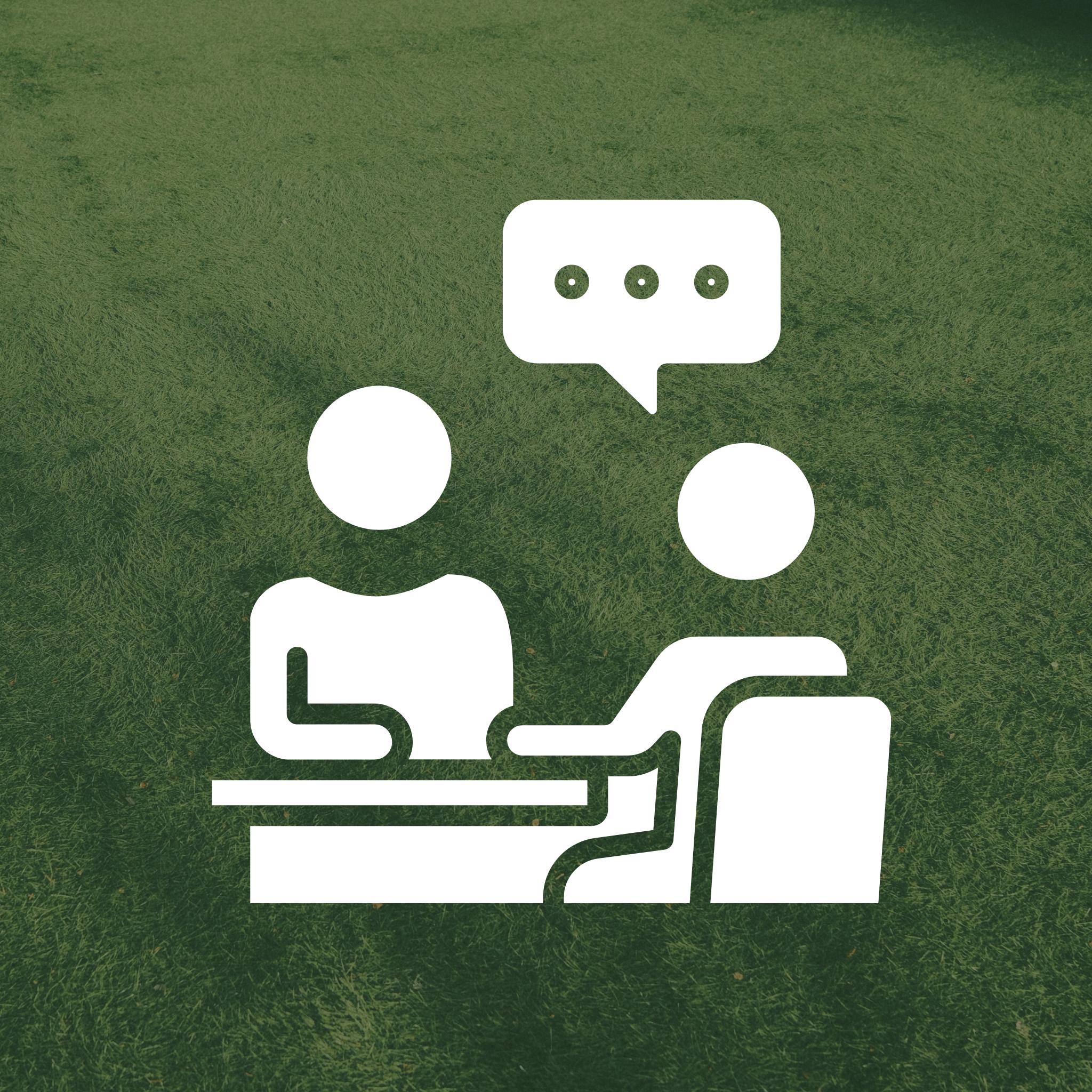White line icon of two people sitting at a desk having a discussion over a green grass background.