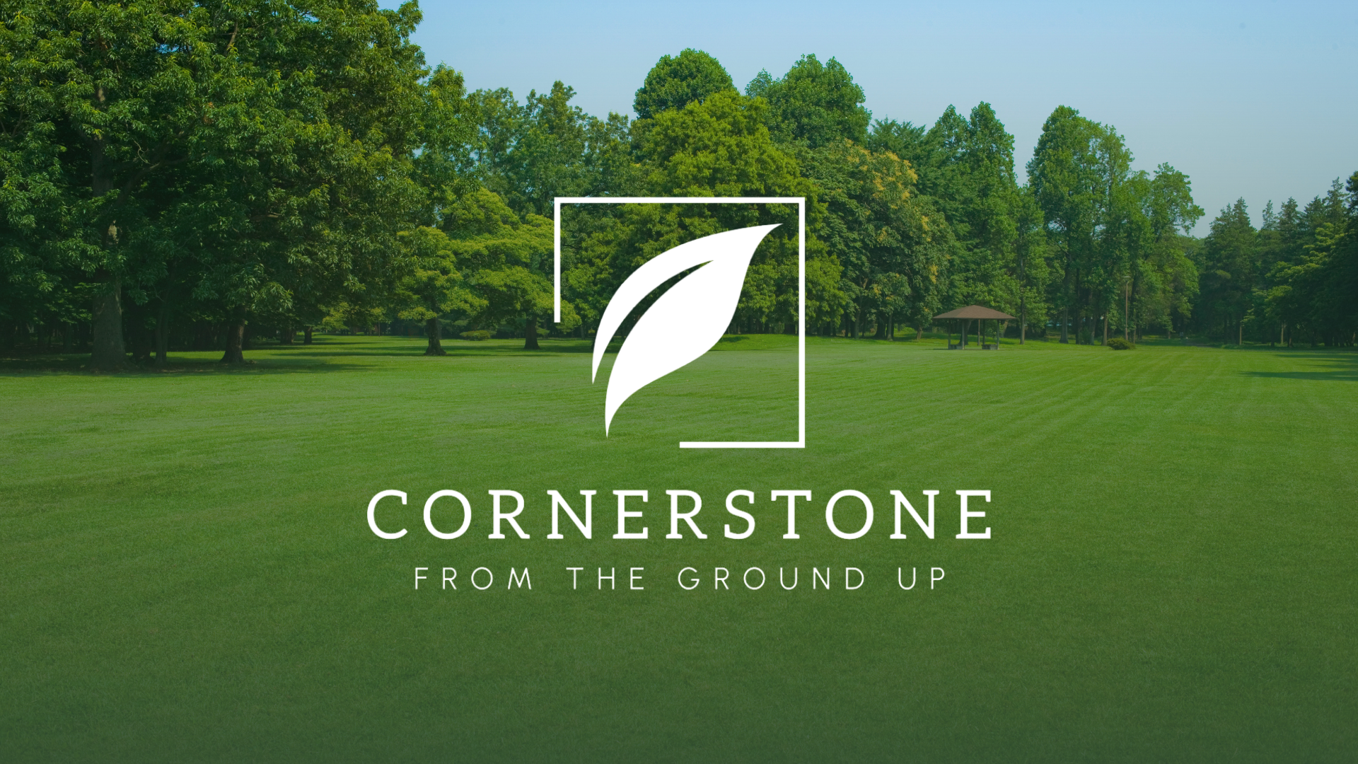 White leaf logo and "CORNERSTONE FROM THE GROUND UP" text over a green park.