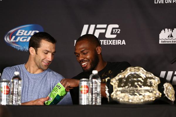 Luke Rockhold shares a snack with light heavyweight champ Jon Jones at the UFC 172 post fight press conference
