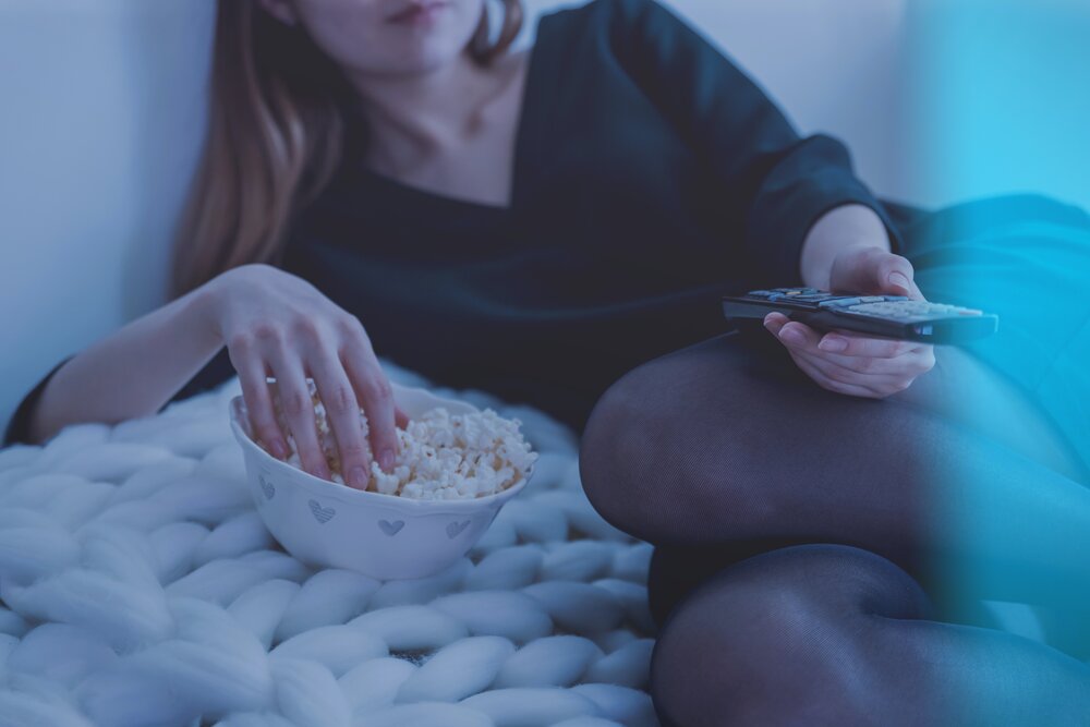 Image: https://www.pexels.com/photo/woman-in-white-bed-holding-remote-control-while-eating-popcorn-1040158/