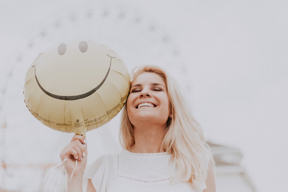 Image: https://www.pexels.com/photo/woman-holding-a-smiley-balloon-1236678/