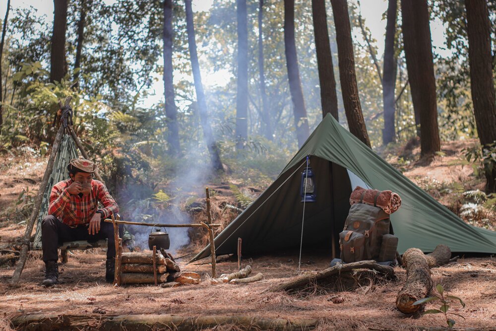 Image: https://www.pexels.com/photo/hiker-resting-near-fire-and-tent-during-travelling-4314203/