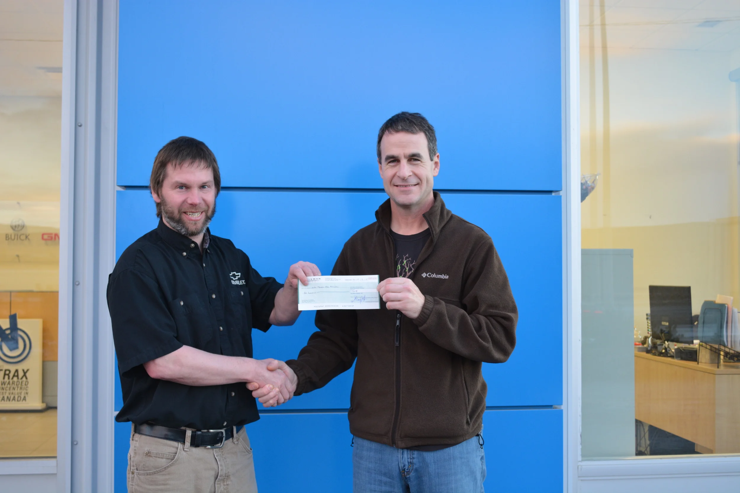 Shawn, HMBA President (left), accepting the donation from Talisman employee, Colin Hanington (right). 