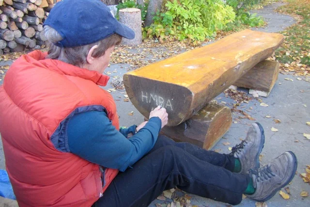 Maureen etches "HMBA 16" onto the bench destined for the EZ Lookout.
