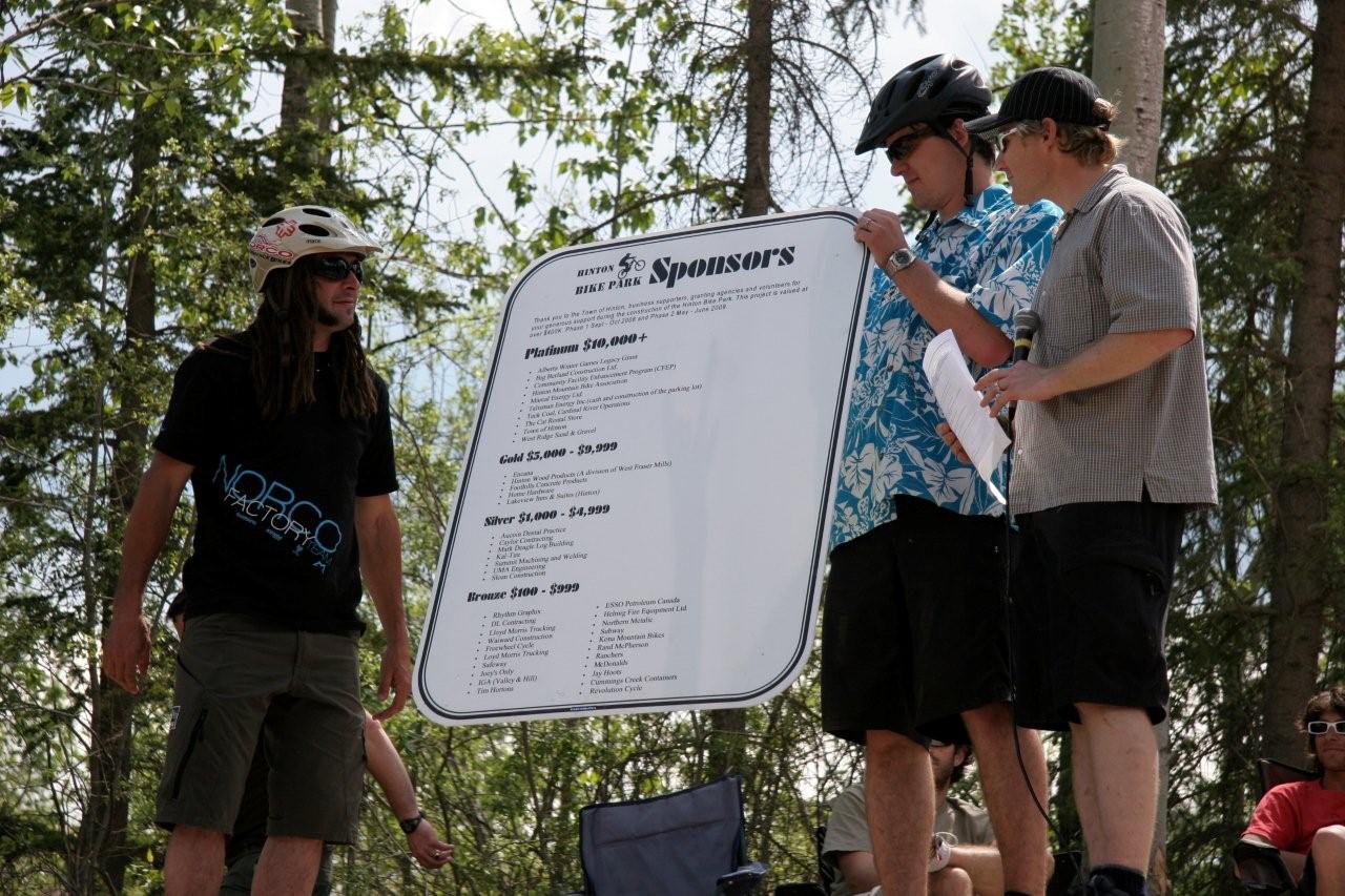 Jay Hoots (left), Jay Hore (middle) and Stephen Hanus (right) displaying the sponsor board for the Hinton Bike Park