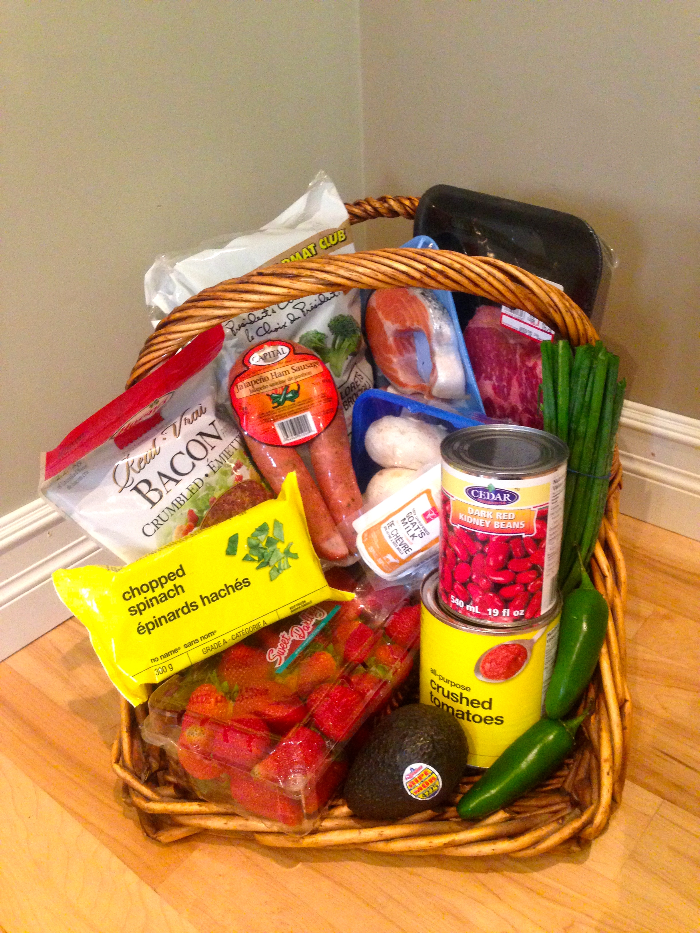 This is a basket of food I purchased today. I managed to stumble upon salmon & rib steak at 30% off, goat cheese, jalapeño sausage and large mushrooms at 50% off and kidney beans at 12% less than I would normally pay. The discounts were equivalent to 44% of the total price paid. The rest of the purchase: broccoli, spinach, bacon bits, canned tomato, jalapeños, avocado and green onion round out the purchase. 
