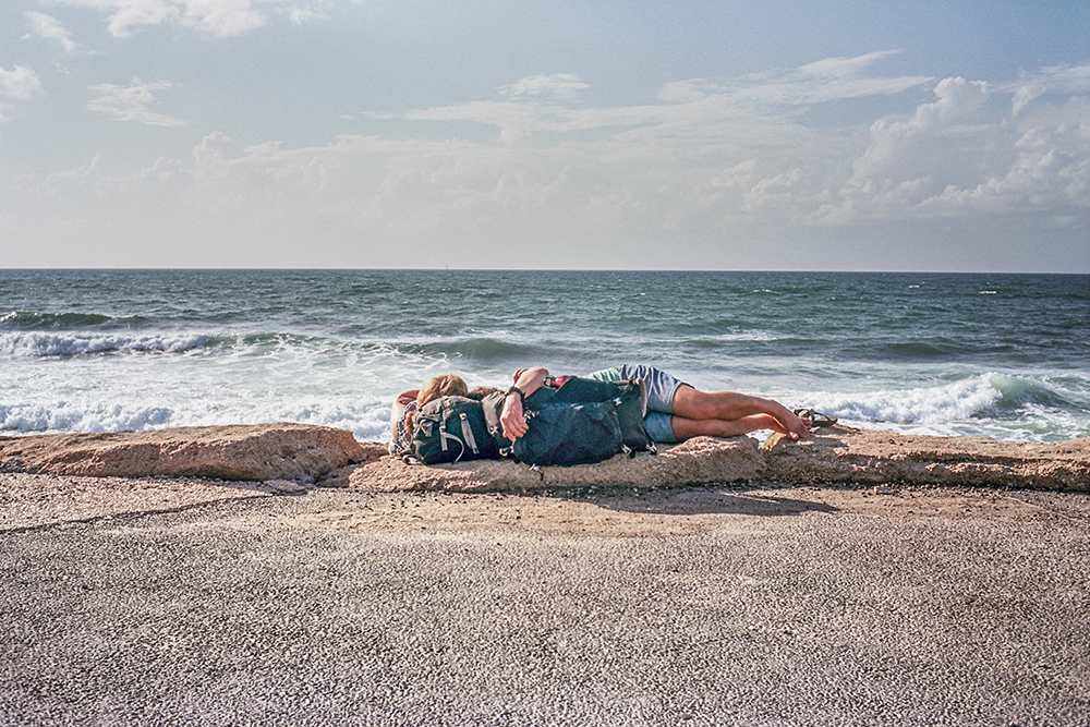 Backpacker Couple resting by the beach in Tel-Aviv_web.jpg