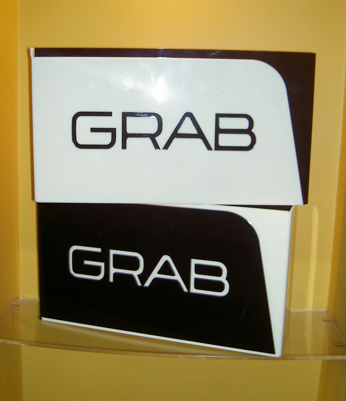  Grab clothing. Signage devices from black and cream acrylic 