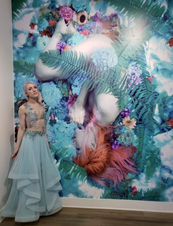 Kindra Nikole with a vinyl wall print of her piece, The Green Dream. From her sold-out three-artist feature show, Origin, at Modern Eden.