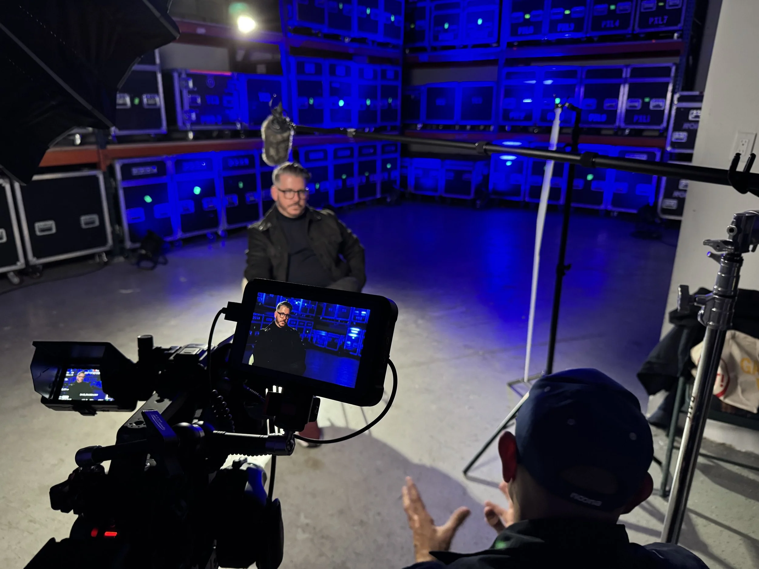 Documentary interview filming setup with camera crew and professional lighting in Miami