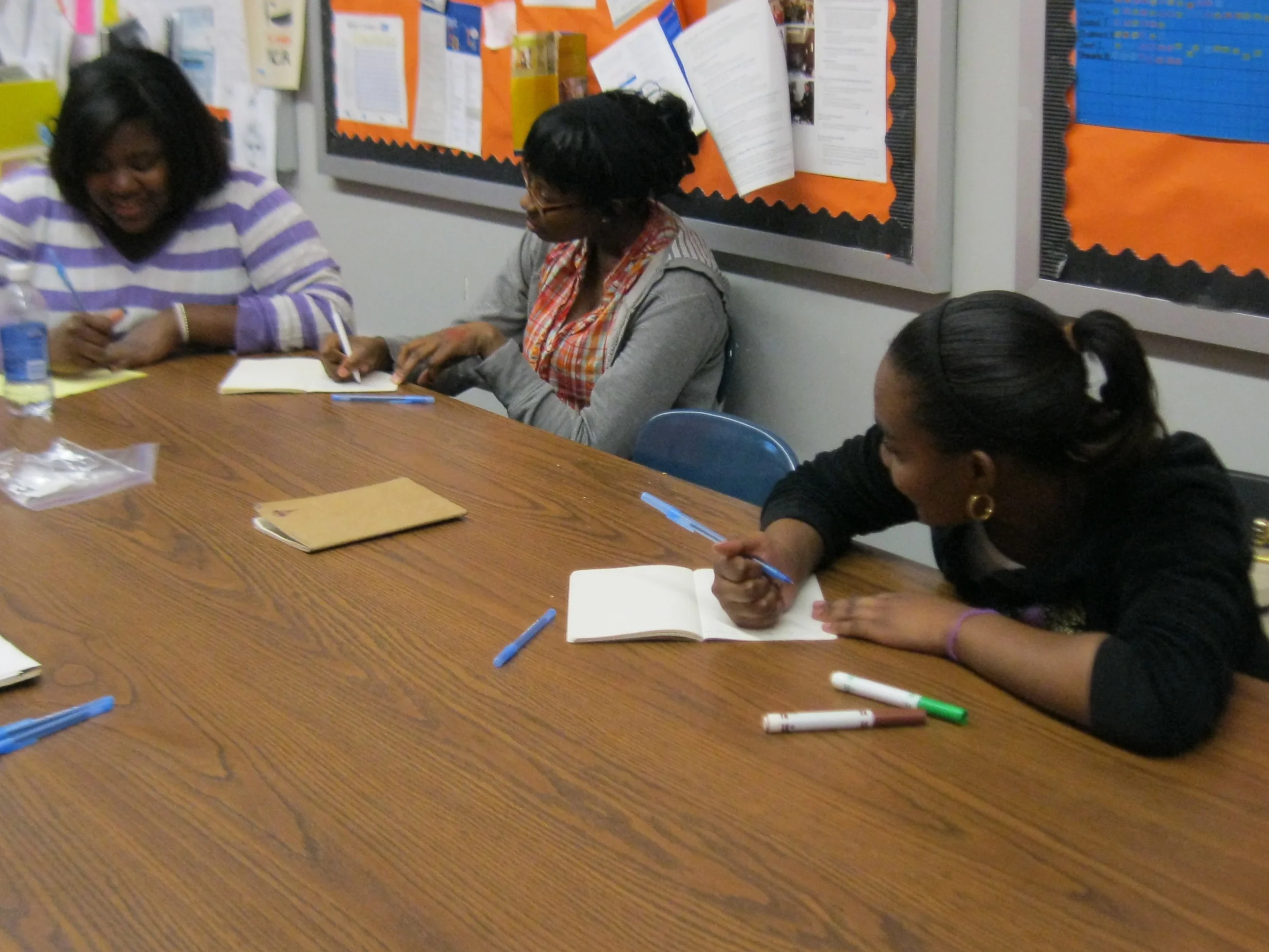 students writing at Parachute's weekly writing workshop at the YWCA Teen Empowerment Program .jpeg