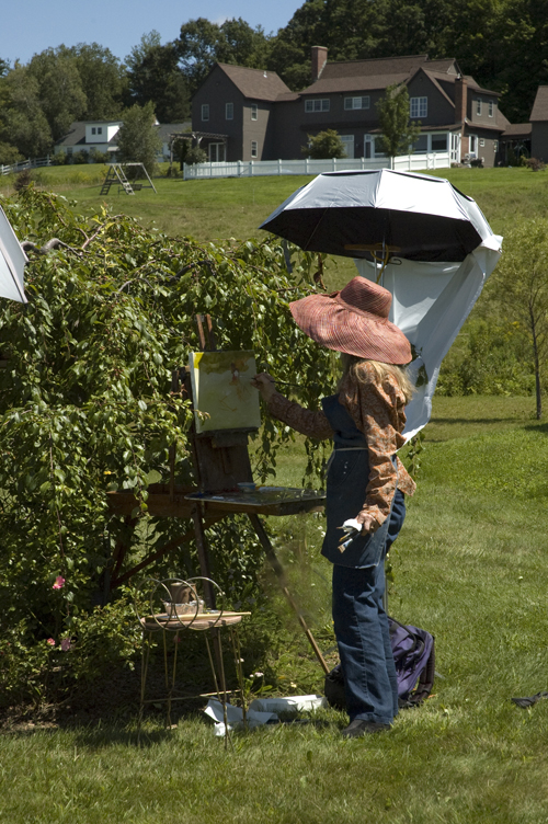 Nancy painting in her gardens.
