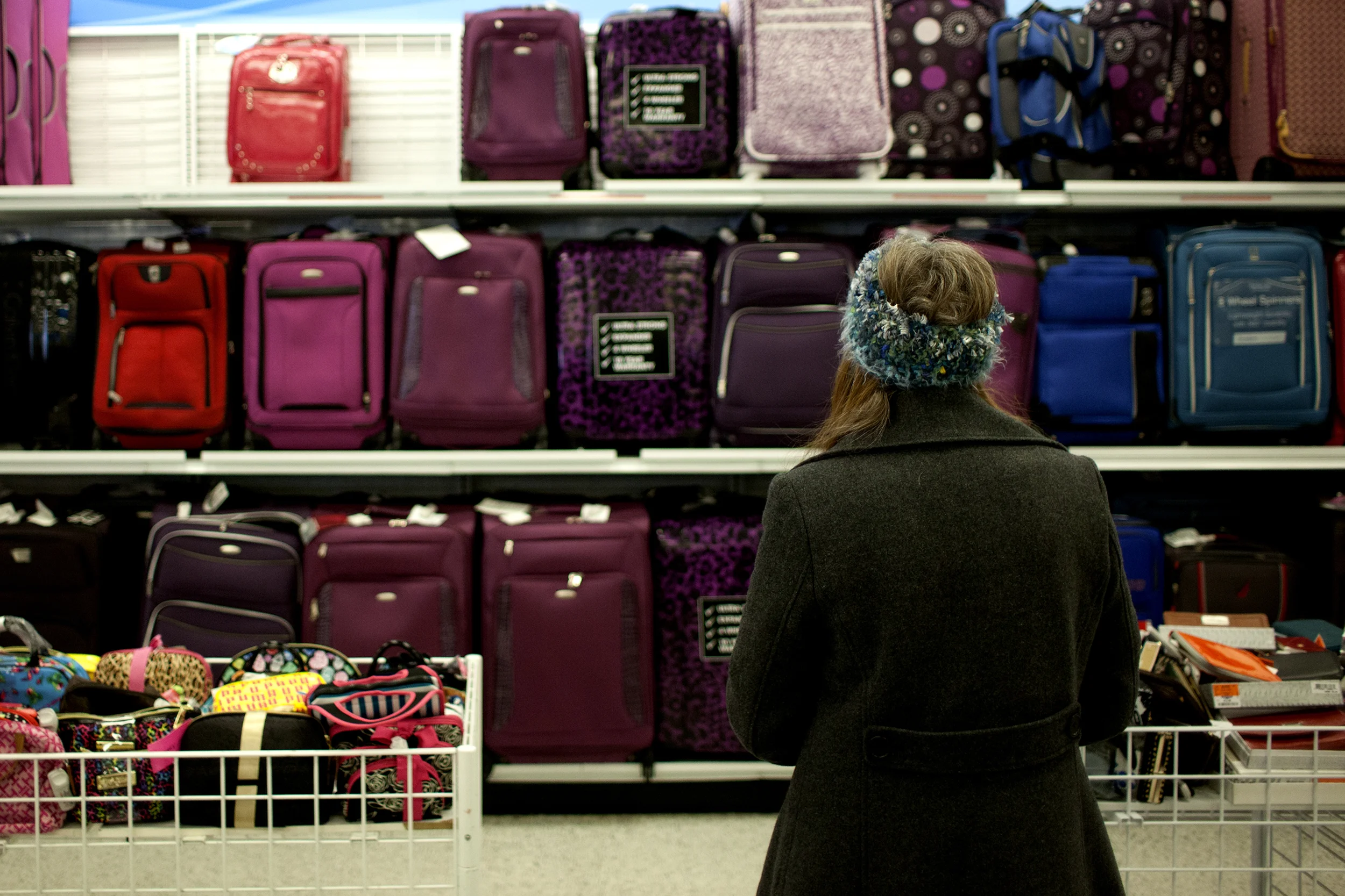 Denver, CO-Kim stands overwhelmed looking at all the options of luggage available. Because of the brain damage, it is difficult for her to narrow down from the many choices. 