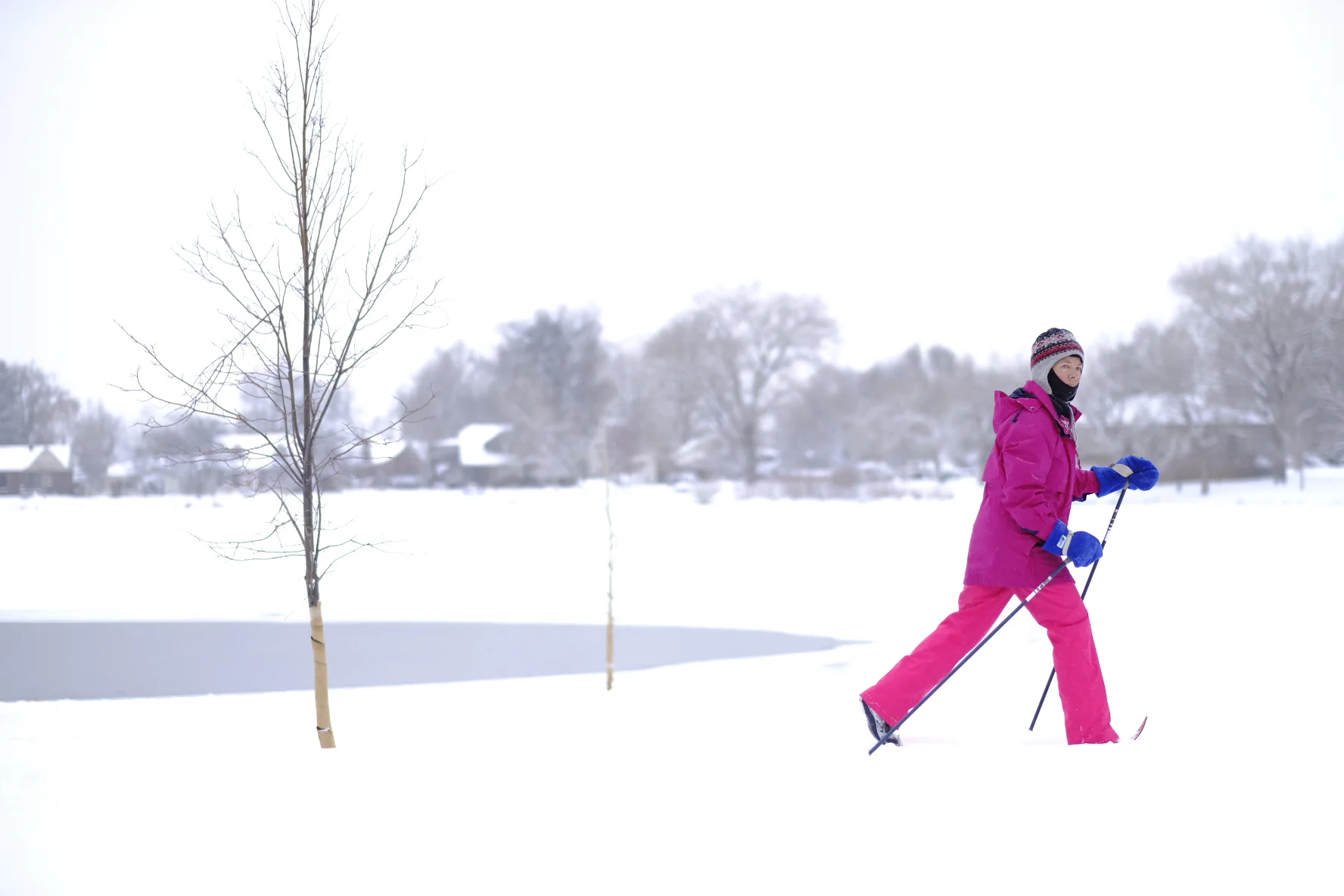 Denver, CO-A late season snow brings a cross country skier to take laps around the frozen lake, Jan. 15 at Washington Park. 