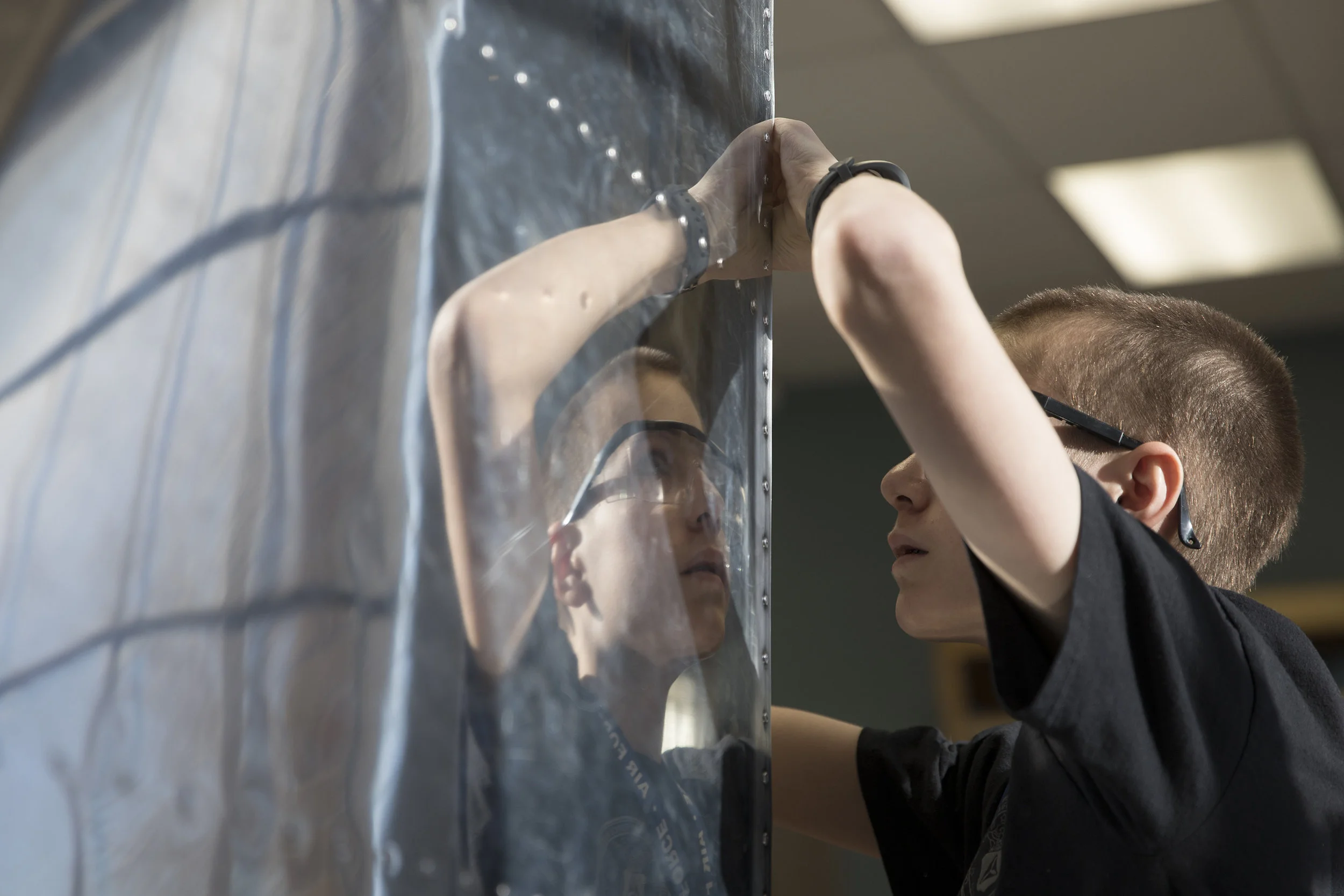 Kael Tapper works on attaching the vertical stabilizer to the fuselage of a Van's RV-12 Aircraft being built by students of the Wings Aerospace Academy, Jan. 17 at Wings Over the Rockies. The students have been building the aircraft since October 2017 and the build is expected to take approximately one and a half years. 