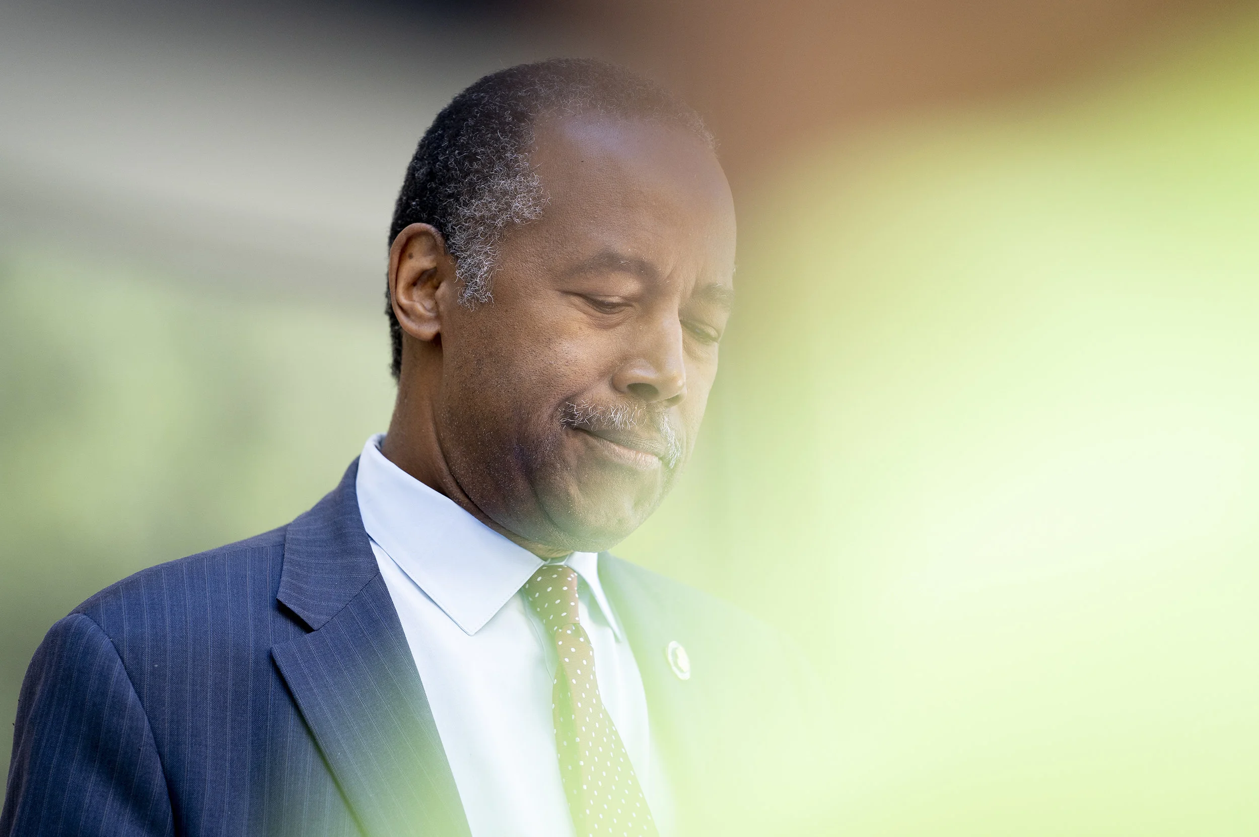 Sec. Ben Carson references his notes as he addresses the crowd at a July 12 ribbon-cutting of the HUD development, Paris Family Apartments, in Aurora.