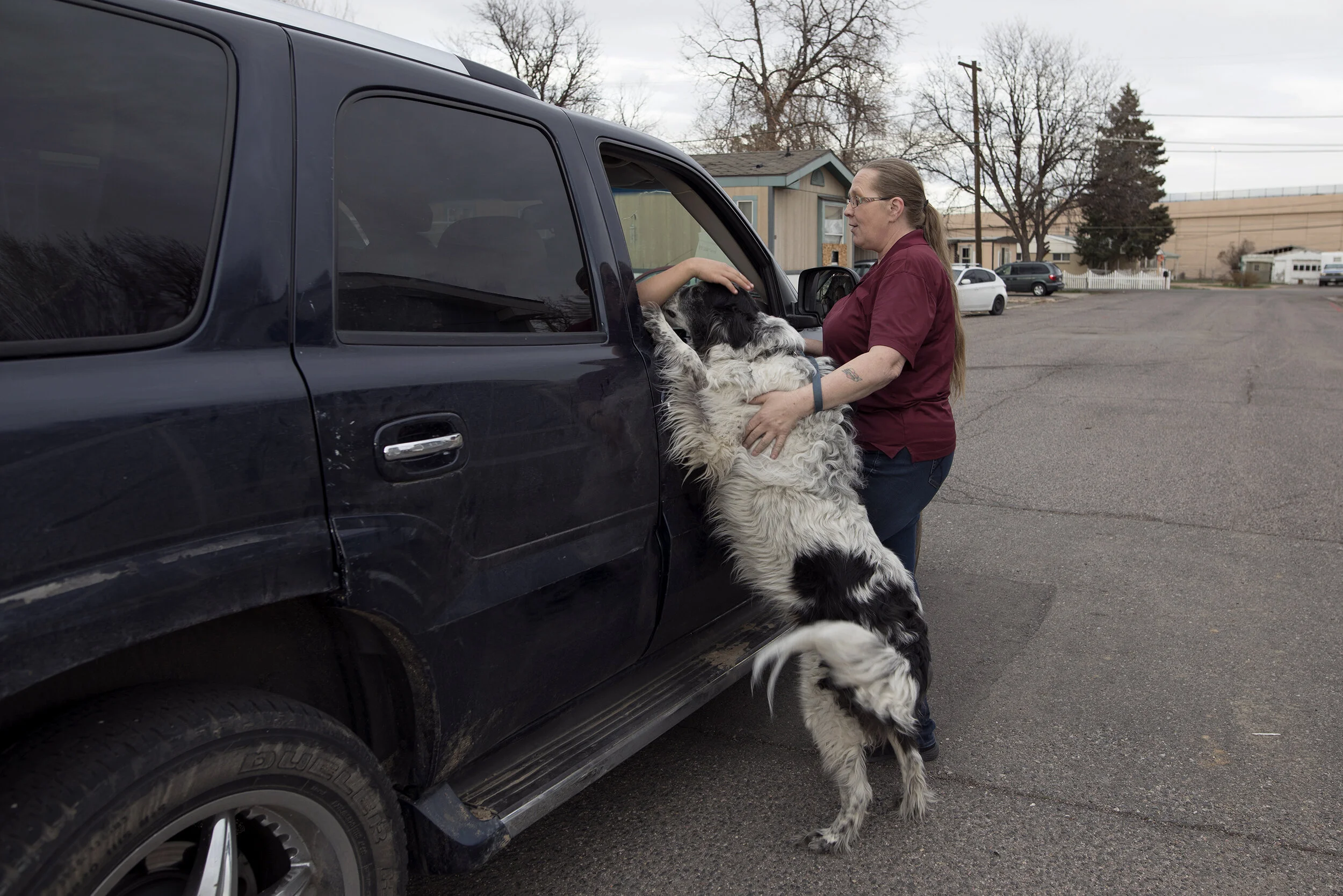 Petra Bennett speaks with one her neighbors on a walk with her dog Romeo, March 30, 2018, through the Denver Meadows mobile home park. Bennett says that the park is a tight community where everyone knows everyone else and is very friendly.