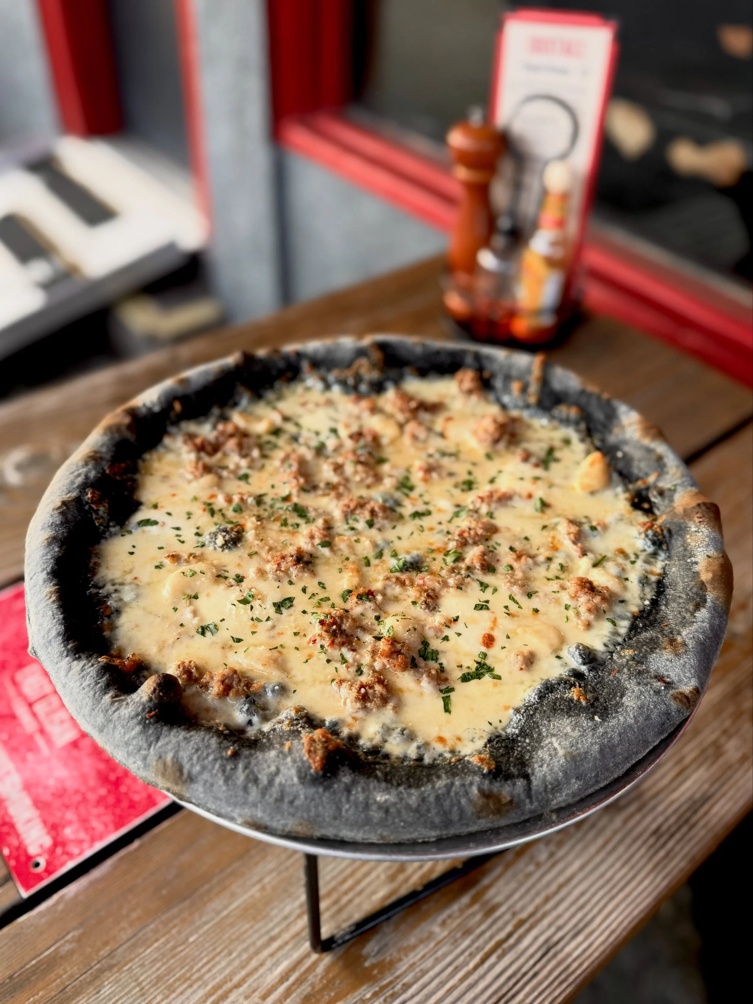 The Vampire Slayer is here, and it&rsquo;s an absolute banger. You&rsquo;re gonna want to sink your fangs into this one ASAP. 

Black (activated charcoal!) 48-hr Sourdough Crust
Roasted Garlic Sauce
More Roasted Garlic
Fennel Sausage
Shredded Mozz
Fr
