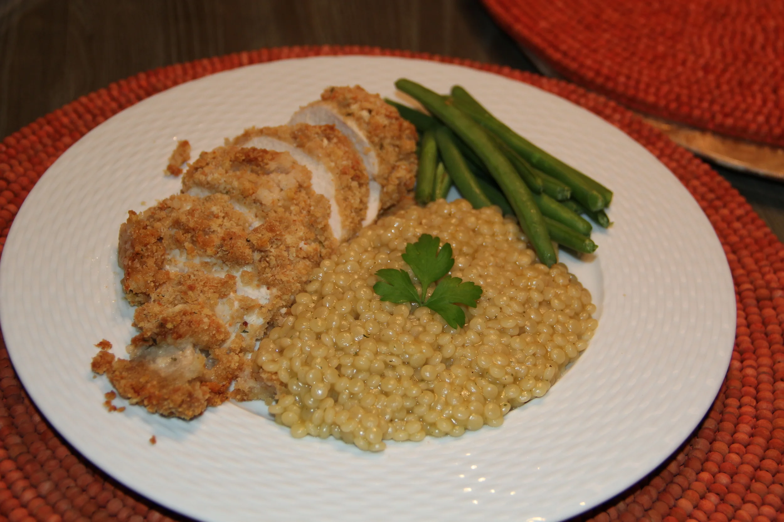 Sliced on the diagonal and served with whole wheat cous cous and steamed haricot verts. 