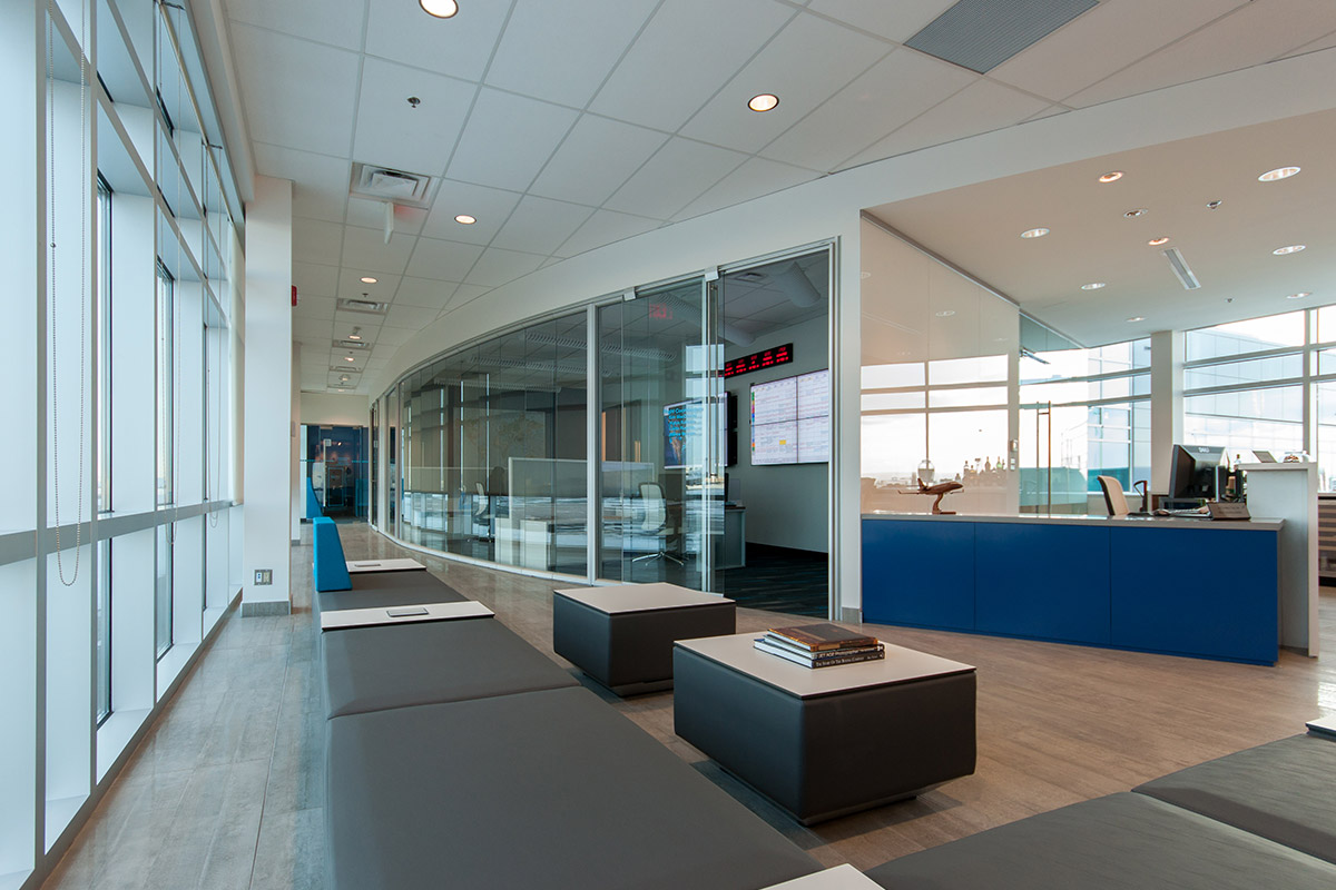 Air Partners YYC International Airport, Calgary 2013 Soft curves and thin planes reference flight in this private air terminal near the International Airport. Faceted Teknion walls create a unique curved corridor experience as users pass through the space.