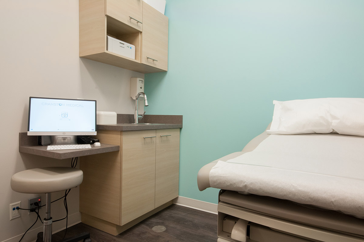 Cranston Medical Clinic Cranston, Calgary 2014 A project completed under the constraints of a limited budget and limited construction schedule. Strips of white vinyl applied in a unique pattern create a low-cost custom look behind the desk.