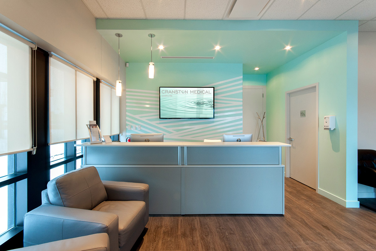 Cranston Medical Clinic Cranston, Calgary 2014 A project completed under the constraints of a limited budget and limited construction schedule. Strips of white vinyl applied in a unique pattern create a low-cost custom look behind the desk.