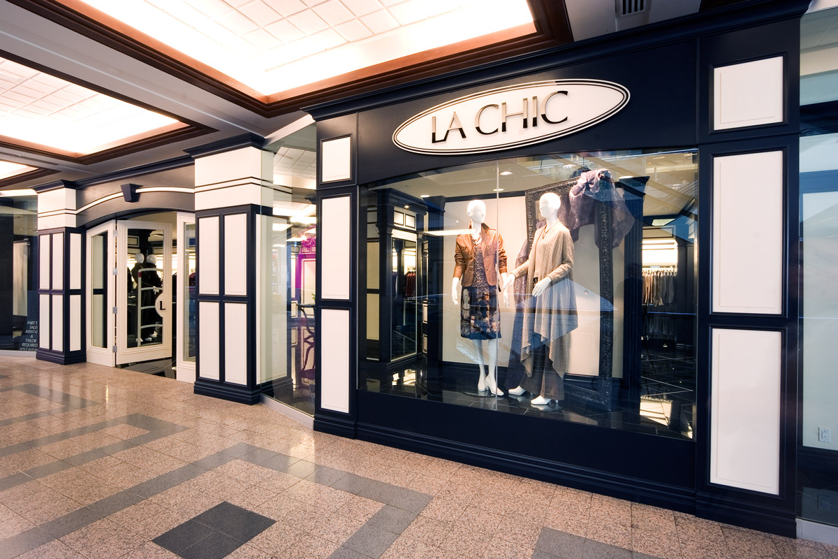 La Chic Bankers Hall, Calgary A high-end boutique retail interior with a high-contrast color and lighting scheme designed to specifically enhance the look of the products for sale. Traditional detailing combined with modern finishes.