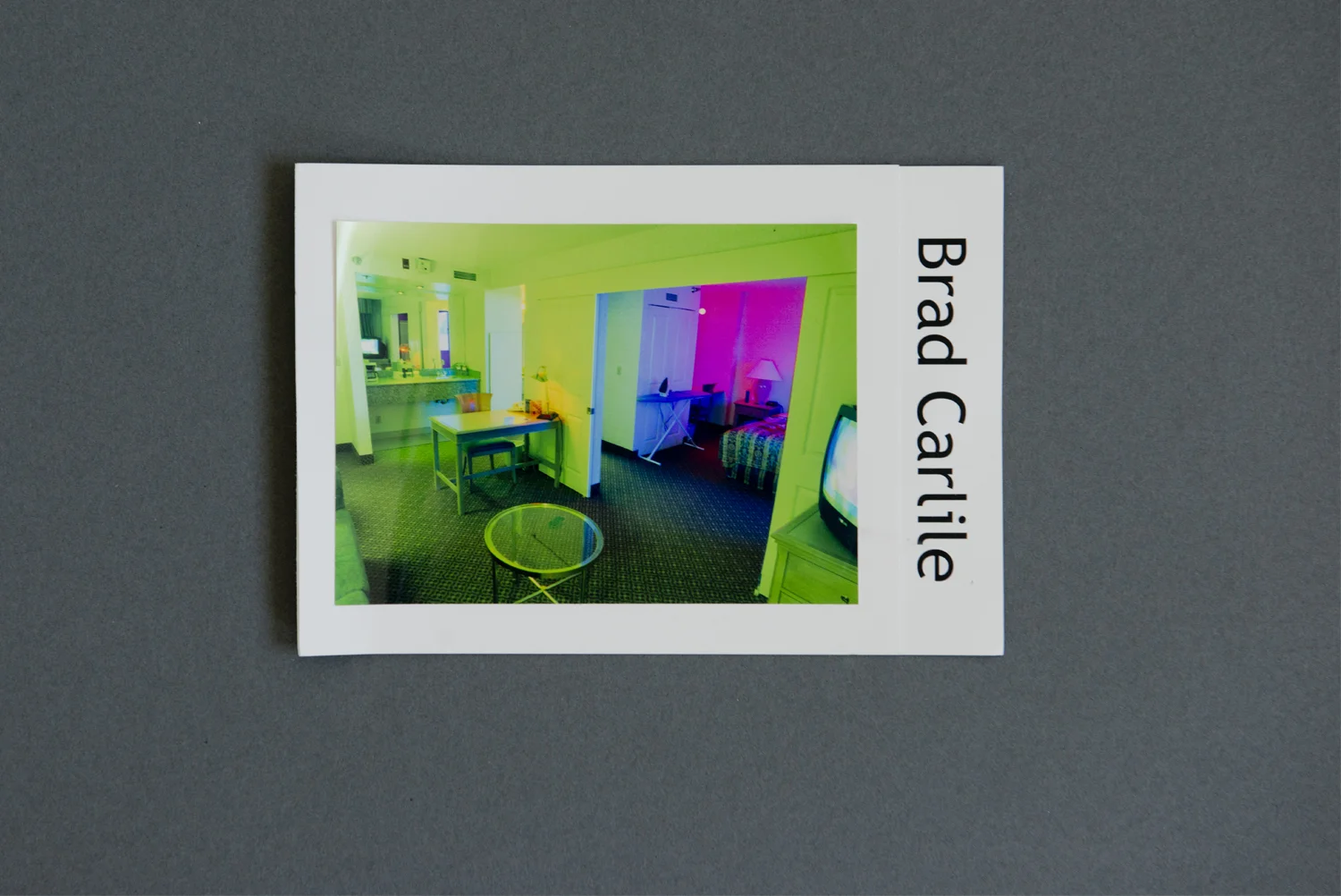Graphically striking and neon-colored, Brad Carlile’s promo card leapt out from our submission pile. The bright colors and distorted perspective of the front photograph are balanced by the bold, sans-serif font of his vertically oriented name.