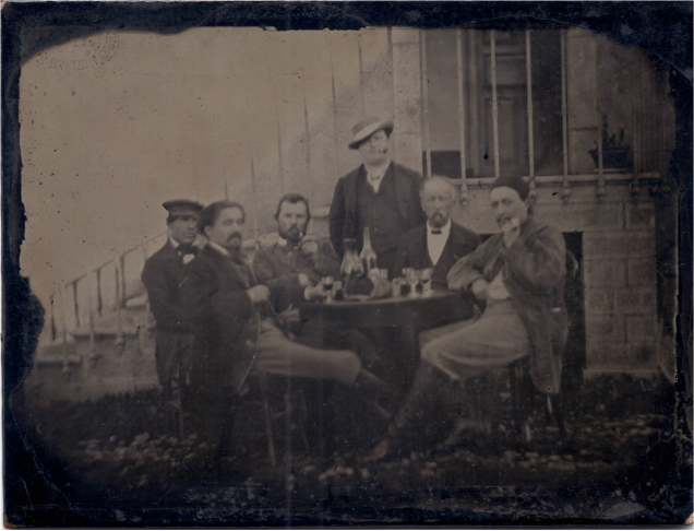 Vincent Van Gogh (third from the left) with friends at dinner.