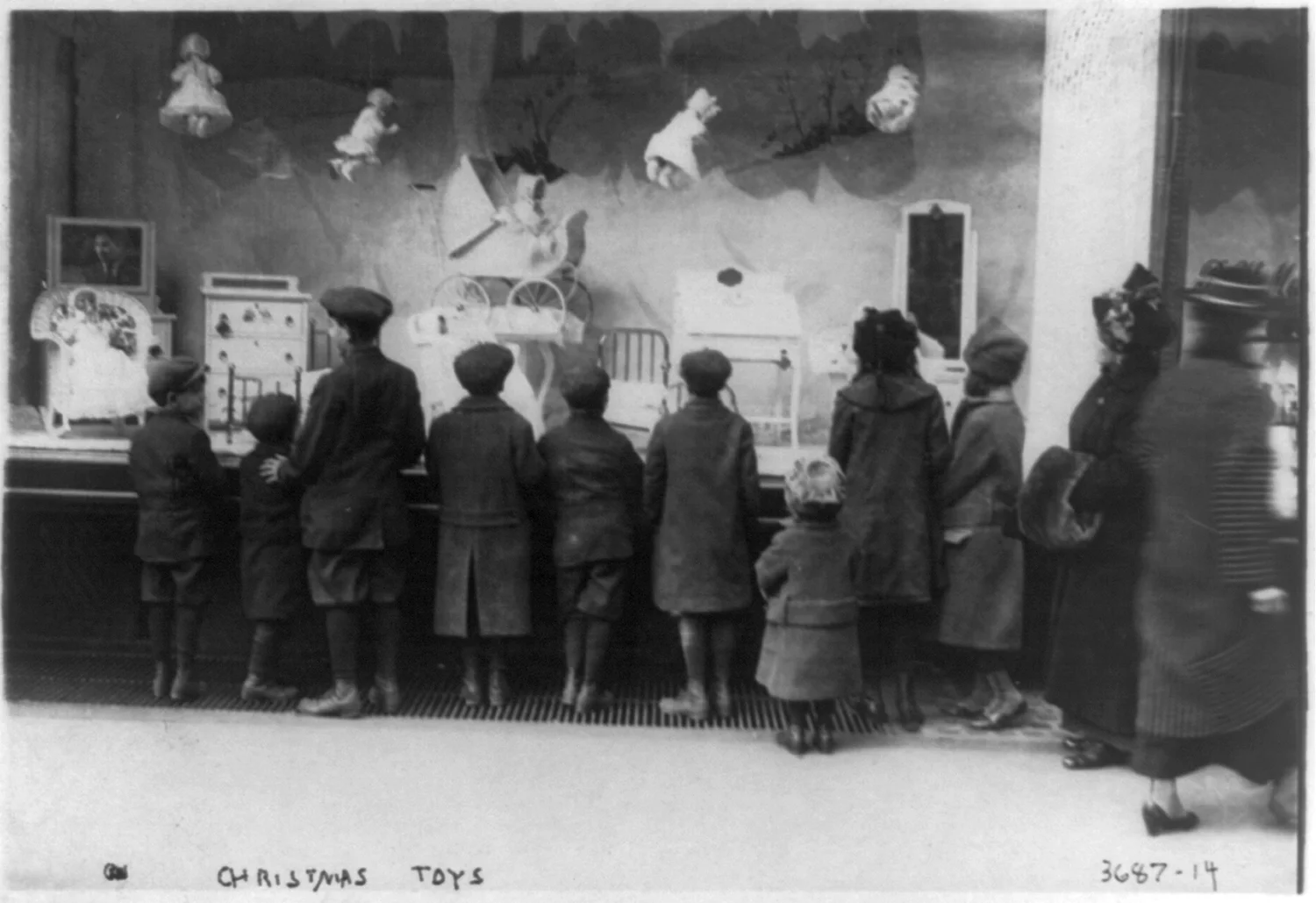Children look through Macy's toy department window, New York City, c. 1908-1917.