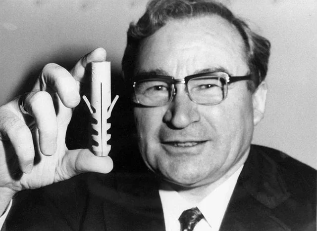 Artur Fischer holding his patented drywall anchor. Photo: Fischerwerke