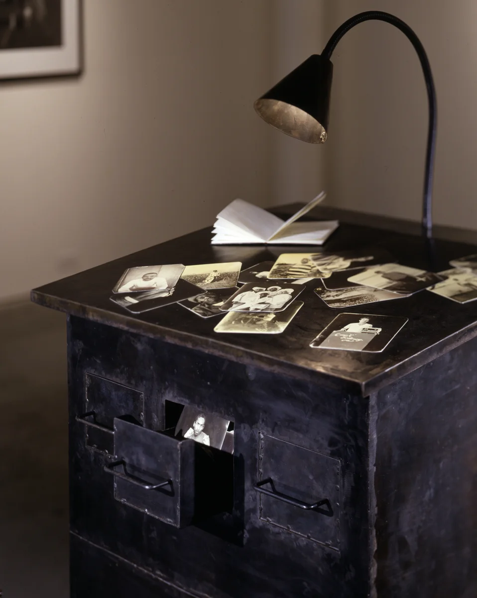 One Big Self: Prisoners of Louisiana (installed 2004 at Jack Shainman Gallery), 1998-2002 photograph, silver emulsion on 288 aluminum plates, steel cabinet, and lamp ©Deborah Luster. Courtesy of the artist and Jack Shainman Gallery, New York.