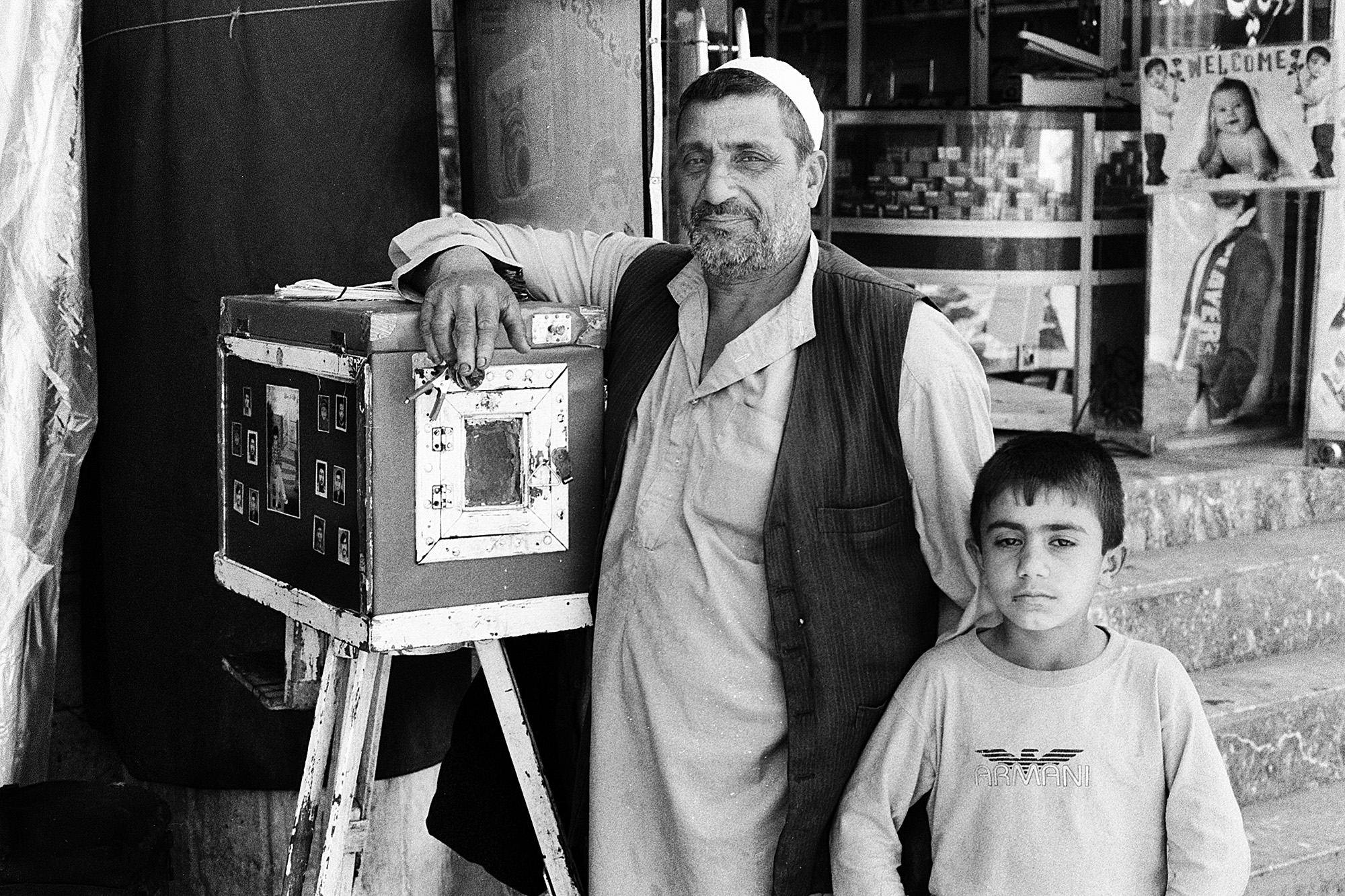 Roh Ullah, a Box Camera photographer with son. Kabul, 2011.