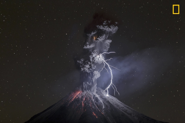 The power of naturePowerful eruption of Colima Volcano in Mexico on December 13th, 2015. That night, the weather was dry and cold, friction of ash particles generated a big lightning of about 600 meters that connected ash and volcano, and illuminated most of the dark scene. On last part of 2015, this volcano showed a lot of eruptive activity with ash explosions that raised 2-3 km above the crater. Most of night explosions produced incandescent rock falls and lightning not bigger than 100 meters in average. Photo and caption by Sergio Tapiro Velasco / National Geographic Travel Photographer of the Year