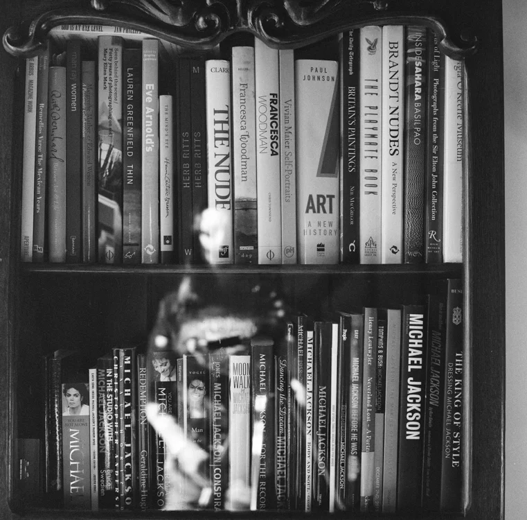 Hannah Kozak ’s self-portrait with her photobook library.