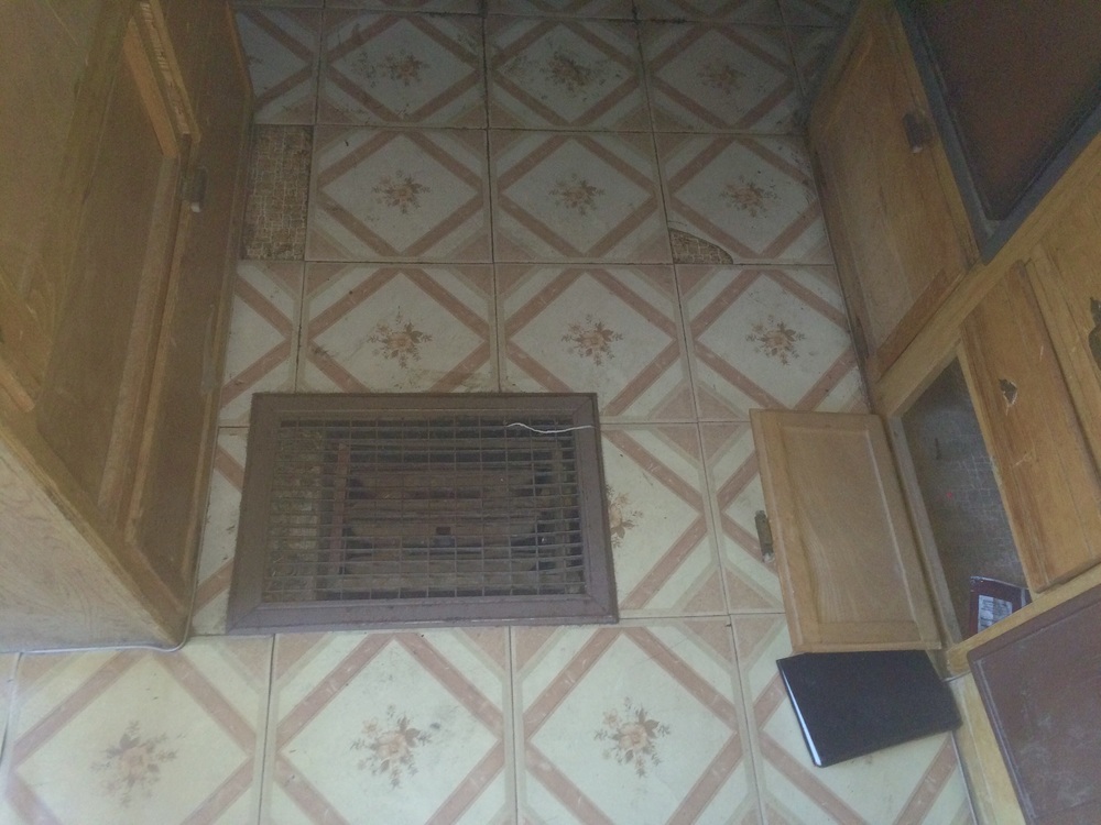 Water-filled radiator propane heater in the floor. 